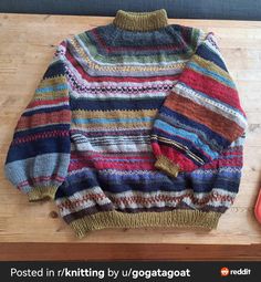 a colorful sweater sitting on top of a wooden table