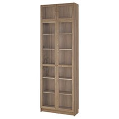 a wooden bookcase with glass doors on the front and bottom shelves in light brown