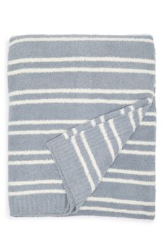 the blue and white striped blanket is folded up