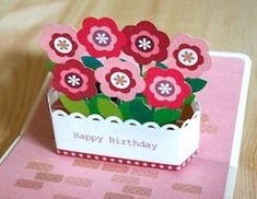 a birthday card with flowers in a box