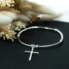 ⭐️925 Sterling Silver Cross Charm Bead Bracelet⭐️ ⭐️   CHARM / BEAD SIZES:  2, 2.5, 3 & 4mm round Beads 30x2mm curved bars 26mm Cross Charm ⭐️ MATERIALS:  925 Sterling Silver, High Quality Jewellery Elastic, Specialist Jewellery Cement.  ⭐️  SIZES:  Standard 17cm / 6.70 inches (Approx inner circumference) Large 19cm / 7.50 inches (Approx inner circumference).  N.B. We are happy to make bespoke sizes, please contact us for more information.  ⭐️  Handmade By us in UK ⭐️ PACKAGING:  Each item arriv Curved Bars, Charm Bead Bracelet, Silver Cross Bracelet, Bead Sizes, Signature Jewelry, Bracelet Sterling Silver, Cross Bracelet, Bead Charm Bracelet, Bracelet Charm