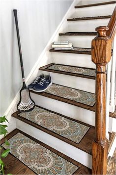 a set of stairs with a broom and shoes on the treads next to it