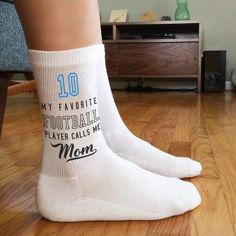 Of course mom's favorite player calls her Mom! These socks are personalized with a player number printed in the team color that will delight any mom who is cheering on her player. The perfect pair of socks for every football mom to wear all season long Socks are available in 4 sizes Cotton/Nylon fabrication, ½ cushion sole Design is digitally printed on the socks with eco-friendly apparel inks Machine wash warm, non-chlorine bleach only, and tumble dry Sold by the pair Print-to-order and hand pr Football Moms, Personalized Socks, Call Mom, Personalized Football, Moms Favorite, Custom Socks, Call My Mom, Men's Shoe, Sports Mom