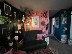 a living room filled with furniture and pictures on the wall