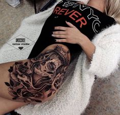 a woman with a black and grey tattoo on her arm