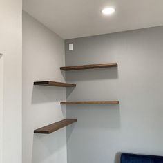 an empty room with some shelves on the wall