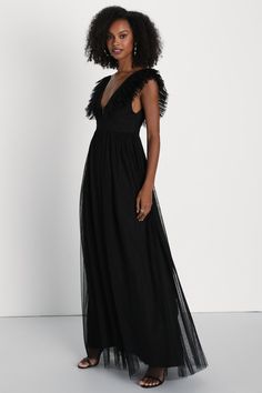 We can't wait for the perfect occasion to come around so we can stun everyone with the Lulus Simply Delighted Black Mesh Ruffled Backless Maxi Dress! This stunning dress is composed of sheer mesh fabric (atop a matching knit liner) that shapes wide straps adorned with flouncy ruffled trim, wide straps, and a sleeveless bodice with a sultry backless design. A high, banded waist tops a twirl-worthy, A-line skirt that cascades down to a sweeping maxi hem. Hidden back zipper/clasp. Fit: This garment Sheer Maxi Dress For Gala During Prom Season, Party Dress With Mesh Sleeves And V-neck, Chic V-neck Mesh Dress For Evening, Glamorous Tulle Mesh Dress For Night Out, Formal Tulle Dress With Feather Trim, Sheer V-neck Maxi Dress For Evening, Evening Tulle Dress With Feather Trim, Black Mesh Tulle Skirt Dress For Party, Black Tulle Mesh Dress For Party