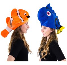 two women wearing funny hats with fish on the front and one has an ear flap