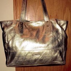 Barely Used. High Quality Fossil Cowhide Leather. Double Handle. 10” Strap Drop. Snap Top. Can Be Used As An Open Shopper Tote Or Converted With The Inside Hook To Make It More Of A Shoulder Bag. Large Inside Zipper Pocket Was Never Used. Embossed Logo Tag Front And Inside. Features Two Slot Pockets And Studded Handles. Also A Hook To Hang Your Keys. Lining Is A Heavy Duty Tan Twill Fabric And Looks Like New Inside. Smoke Free, Pet Free Home Gold Leather Bag For On-the-go, Gold Leather Satchel With Handles, Gold Double Handle Shoulder Bag For On-the-go, Gold Shoulder Bag With Double Handle For On-the-go, Gold Soft Leather Bag For On-the-go, Gold Leather Bags With Handles, Gold Soft Leather Bag, Gold Leather Satchel With Leather Handles, Gold Leather Shopping Bag