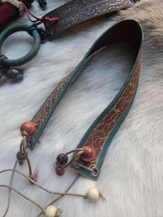 a close up of a horse's bridle on a white fur surface