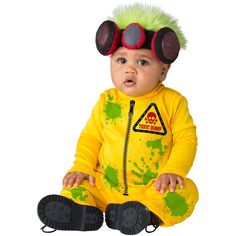 a baby sitting on the ground wearing a yellow outfit with green hair and goggles