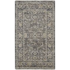 a rug with an ornate design on the front and back side, in grey tones