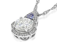 2.50ct round lab created Strontium Titanate and .09ctw trillion cut tanzanite with .22ctw round white zircon, rhodium over sterling silver pendant and 18 inch Singapore chain. Measures approximately 5/8" L x 3/8" W and has a lobster clasp and two inch extender. Accent stones primarily zircon. Trillion Cut Cubic Zirconia Jewelry With Diamond Accents, Silver Jewelry With Trillion Cut Diamond Accents, White Gold Jewelry With Trillion Cut Accent Stones, Trillion Cut Center Stone Jewelry In White Gold, White Gold Jewelry With Trillion Cut Center Stone, White Trillion Cut Jewelry For Anniversary, Fine Jewelry With Trillion Cut Center Stone, Trillion Cut Diamond Jewelry With Accent Stones, Trillion Cut White Gold Jewelry With Accent Stones