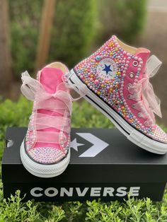 "Custom Bling Converse All Star Chuck Taylor Sneakers. All designs handmade and embellished with a variety of high quality crystals. Good for weddings, proms, homecomings, birthdays, special events or just your everyday girly girl. Bling Converse \"HIGH TOP\" Can customize to any color Embellished with pink, blue, yellow pearls Pink Crystal rhinestones Pink sheer ribbon shoe strings (original shoe strings provided with all orders) (NEW SHOES GUARANTEED) Rhinestone Bling Pearls Satin Shoelaces ** Satin Shoelaces, Upcycle Shoes, Rhinestone Converse, Converse Design, Bling Converse, Ribbon Shoes, Pink High Tops, Converse High Top, Taylor Outfits