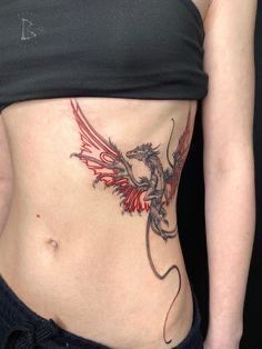 a woman with a dragon tattoo on her stomach