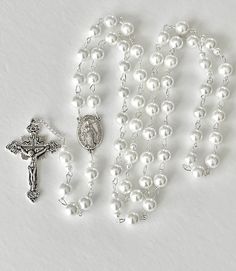 Handmade rosary. Made with silver metal wire and 8mm glass faux pearls. Crucifix measures 1 3/4 inch x 1 1/4 inch. Comes in a gift pouch Silver Beaded Rosary For First Communion, Silver Pearl Rosary With 8mm Beads, Elegant Pearl Rosary With Cross, Elegant Silver Rosary For First Communion, Elegant Pearl White Pearl Rosary, Silver Pearl Rosary For First Communion, Wedding Silver Pearl Rosary, Silver Pearl Rosary Bracelet For First Communion, Elegant White Rosary With Round Beads