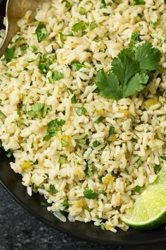 rice with cilantro and lime in a black bowl