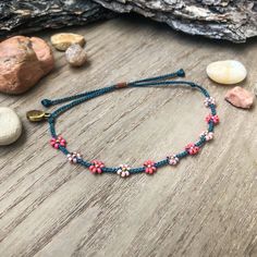 "Introducing my first \"Little Flower\" design! This color palette was inspired by blossoming trees. We see a lot of pinks on the trees around us in the spring, the sweet smells and soft petals on the ground that my kids will inevitably pick up. Happy colors!  This bracelet matches perfectly with the seed bead version, found here: https://colorsoftheprairie.etsy.com/listing/1451854024 Please keep in mind that even though I try my best to keep the spacing even between flowers, I'm not a machine and the spaces are not all perfectly equal. I think this adds to unique-ness and similarity to wild flowers in nature! They don't grow in straight lines! But if you are unhappy, please let me know ASAP and see my \"Happiness Guarantee\" down below. This listing is for 1 adjustable seed bead bracelet Adjustable Beaded Bracelets For Spring Festival, Pink Beaded Bracelets For Spring Festival, Bohemian Beaded Bracelets For Spring, Bohemian Beaded Bracelets For Everyday Spring Wear, Spring Festival Pink Beaded Bracelets, Bohemian Beaded Bracelets With Tiny Beads For Spring, Adjustable Colorful Beads Friendship Bracelets For Spring, Spring Bohemian Beaded Bracelets With Tiny Beads, Adjustable Flower Beaded Bracelets For Summer