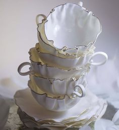 a stack of white cups sitting on top of each other