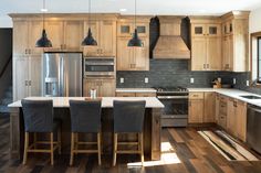 a kitchen with wooden cabinets and gray chairs