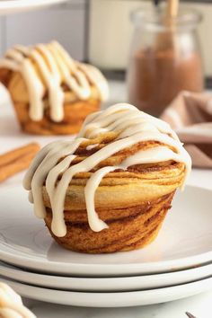 a cupcake with icing sitting on top of a plate next to other pastries