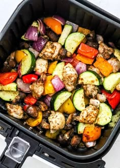 a pan filled with meat and vegetables on top of a table