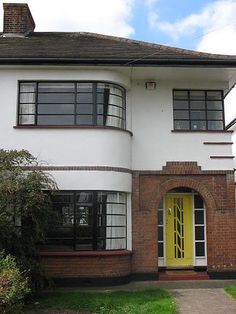 a large white house with a yellow door