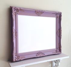 a white shelf with a purple frame on it