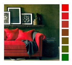 a living room with red and green colors on the walls, couches and pictures