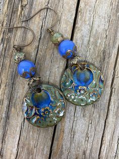 The ceramic focal pieces are handmade and come from one of my favorite artists in Spain. Her work is exceptional. What really catches your eye are the blue Chalcedony beads the color is gorgeous. The Chalcedony is set in a bead cap and  on top of it is another bead cap with a Czech glass bead. The earrings are 3.5 inches long  and 1.25 inches wide. Gilbert Az, Drop Dangle Earrings, Earrings Drop, Handcrafted Earrings, Blue Chalcedony, Earrings Boho, Bead Caps, Blue Earrings, Czech Glass Beads