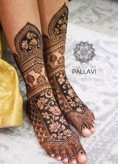 the legs and feet of a woman with henna tattoos