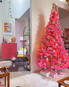 a pink christmas tree in a living room