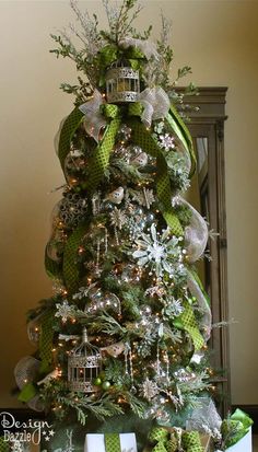 a christmas tree decorated with green and silver ornaments