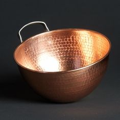 a large metal bowl sitting on top of a table