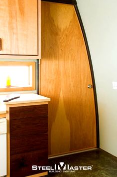 the interior of a small kitchen with wooden cabinets and cupboards, including an oven