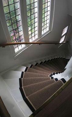 a spiral staircase in a house with glass windows