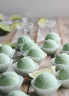 some green and white chocolates on a wooden table