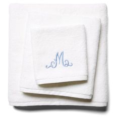 two white towels with blue monogramming on them