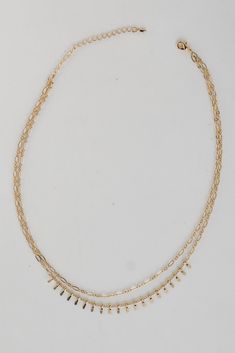 You'll always impress your admirers in the Kaia Gold Layered Chain Necklace! This trendy necklace features two layers of gold chains. Style the Kaia Necklace with any outfit to instantly upgrade your look! Gold Plated Layered Lobster Clasp with Extender Layer 1 | Length 6.5" Layer 2 | Length 6" Extender | Length 3" Dainty Gold Multi-strand Layered Necklace, Double Strand Metal Necklace With Delicate Chain, Dainty Gold Layered Charm Necklaces, Gold Layered Charm Necklace Choker, Gold-tone Multi-strand Layered Necklace, Everyday Multi-strand Gold Chain Layered Necklace, Everyday Multi-strand Gold Layered Necklace, Dainty Metal Layered Necklace With Double Chain, Dainty Metal Double Chain Layered Necklace