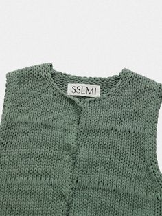 This is a trendy and feminine vest by SSEMI that is made out of high quality and sturdy material. With distinctive mood of the design and comfortable wear, you can style it for your casual daily outfit.- Hidden button down closure on the front- Ribbed hem and heavy gauge knit- Feminine and casual mood Casual Chunky Knit Vest For Winter, Chic Cotton Sweater Vest For Winter, Knit Vest For Spring Layering, Spring Knitted Vest For Layering, Casual Sleeveless Knit Outerwear, Knitted Cotton Vest For Fall, Spring Sleeveless Chunky Knit Sweater Vest, Sleeveless Chunky Knit Top For Spring, Chic Cotton Vest For Winter