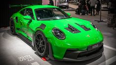 a bright green sports car is on display