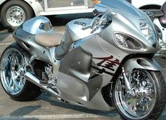 a silver motorcycle parked in a parking lot