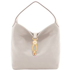 Soft and Chic     The Logo Lock Shoulder Bag owes its soft, slouchy shape and understated style to natural Florentine leather. A gold plated closure keeps contents secure, a wide shoulder strap guarantees comfort and a roomy interior provides great storage space. Both casual and chic, this bag will take you from workday lunches to Sunday brunches with ease. Handbags Hobo, White Shoulder Bags, Dooney & Bourke Bag, Gray Handbags, Monogram Pendant, Understated Style, Teal Leather, Satchel Tote, Dooney Bourke Handbags