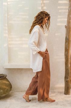 These timeless, slightly loose fitting and wide-legged linen pants are sure to become a favourite in your wear-forever summer closet. Crafted from mid-weight, super soft 100% French Flax Linen, you will wear them on repeat on all your warm weather days. The slightly high-waisted, elasticated waistband serves extra comfort while the effortless design works equally well for everyday vaycay wear as for sophisticated al fresco dining by the seaside. The side pockets feature beige lining to reduce tr Linen Boho Outfit, Bali Clothes Outfits, Wide Leg Linen Pants Outfit, Bali Outfits, Linen Style Fashion, Linen Pants Outfit, Earthy Outfits, Summer Closet, Linen Fashion