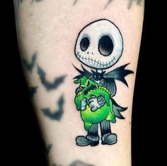 a person with a tattoo on their arm holding a green ball and some black birds in the background