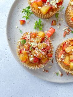 small cupcakes with fruit and nuts on a white plate