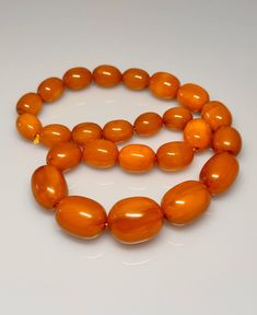 86 Grams Antique Bakelite Necklace Beads Marbled.           Very quality necklace with olive shape. All beads have rich veins. 25 total beads Biggest bead sizes 25.50 x 21 mm.  Smallest bead sizes 17 x 13.40 mm. For any questions feel free to as Amber Oval Beads Single Strand Necklace, Amber Single Strand Necklace With Oval Beads, Amber Oval Beaded Necklaces For Jewelry Making, Amber Oval Beads Necklace For Jewelry Making, Amber Necklace With Faceted Oval Beads, Amber Beaded Necklaces With Large Oval Beads, Amber Necklaces With Polished Oval Beads, Amber Beaded Necklace With Large Oval Beads, Bakelite Necklace