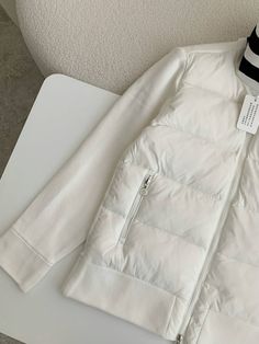 Experience the perfect blend of warmth and style with this Moncler-inspired Down-paneled Cotton Jacket in a refreshing white. This versatile piece seamlessly combines a quilted down-filled body with soft cotton sleeves, offering both exceptional insulation and freedom of movement. The classic white colorway is accented with a contrasting black inner collar and a bold logo patch, adding a touch of sporty sophistication. Whether you're seeking adventure or everyday comfort, this jacket is the perf White Sporty Quilted Outerwear, Sporty White Quilted Outerwear, White Quilted Puffer Jacket, White Quilted Puffer Jacket With Long Sleeves, White Long Sleeve Quilted Puffer Jacket, White Down Outerwear With Padded Collar, White Quilted Jacket For Spring, Winter White Long Sleeve Quilted Jacket, White Puffer Quilted Jacket For Winter