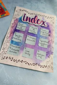 a paper cut out with the word index on it next to some scissors and other crafting supplies