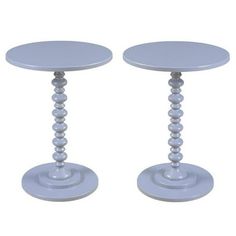 two small white tables sitting next to each other